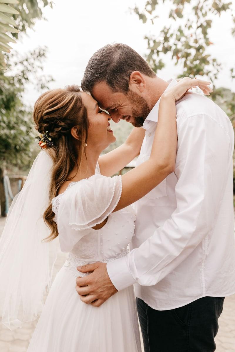 A bride and groom sharing a quiet embrace outdoors